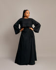 Elegant ruched maxi skirt and matching blouse in shimmering fabric.