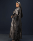 Model wearing the Royal Essence metallic kaftan dress with flowing sleeves and elegant shimmer finish.
